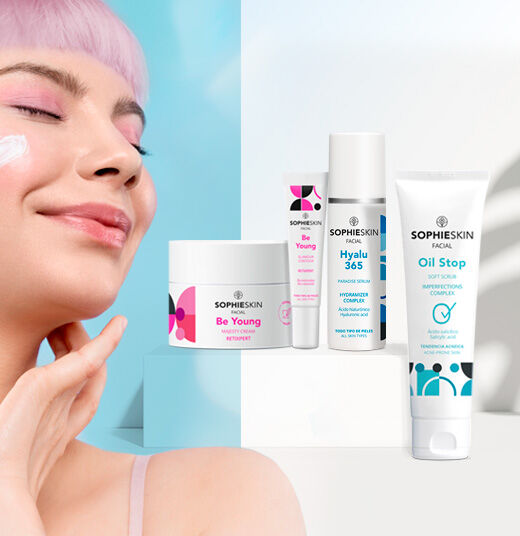 Imagen chica con pelo rosa sonriendo, ojos cerrados y crema en el pómulo, al lado cuatro productos Sophieskin